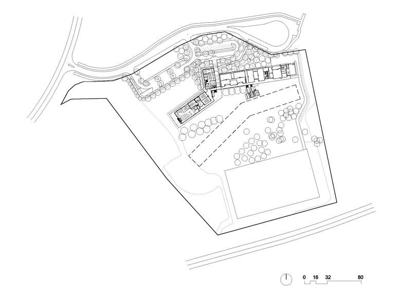 Cantilevered roofs sitting lantern-like atop the weightiness of a concrete block work-base, MacKillop Catholic College in the Northern Territory, roofing, wall cladding, soffits and flashing made from COLORBOND® steel in the colours Windspray®, Jasper®, and Shale Grey™